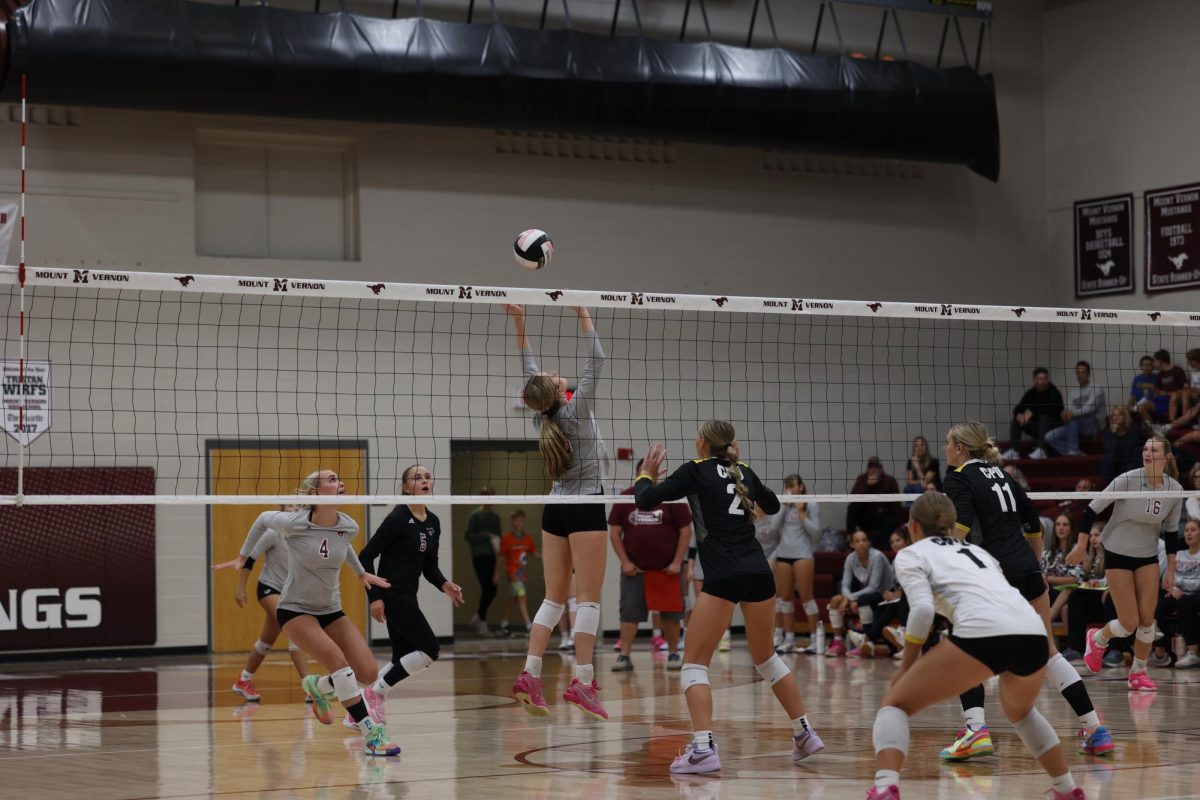 Senior Sydney Huber (15) sets the ball as senior Paige Schurbon (4) gets ready to attack. Sept. 24.