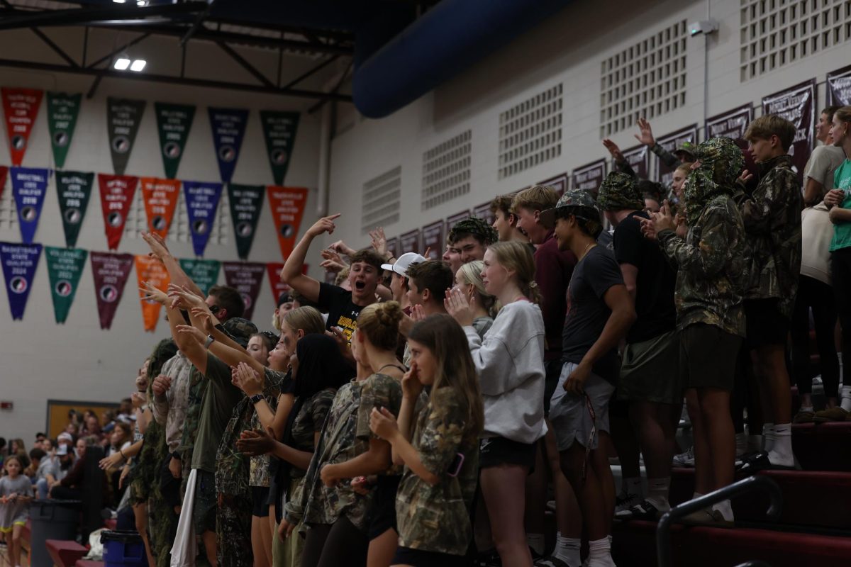 Junior Kellen Haverback leads the student section in their cheer at the Mount Vernon volleyball game Sept. 24.