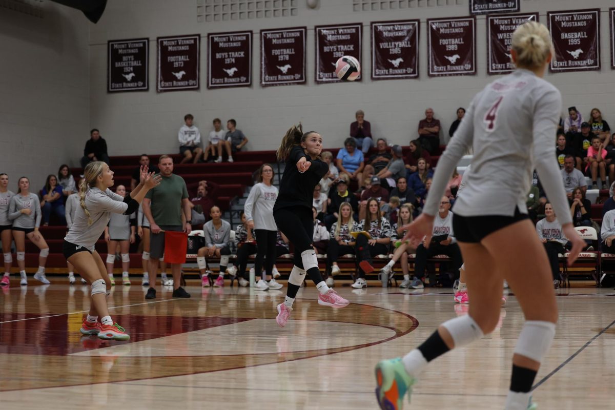 Senior Eryn Jackson (5) hops back as she bumps the volleyball Sept. 24.