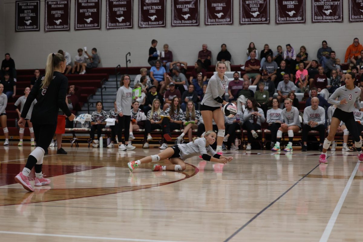 Sophomore Mavrik Schweer (1) dives to save the ball from hitting the ground Sept. 24.