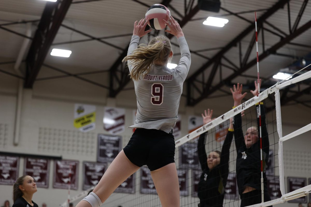 Senior Sydney Maue (9), jumps to set the ball over the net Sept. 24. 