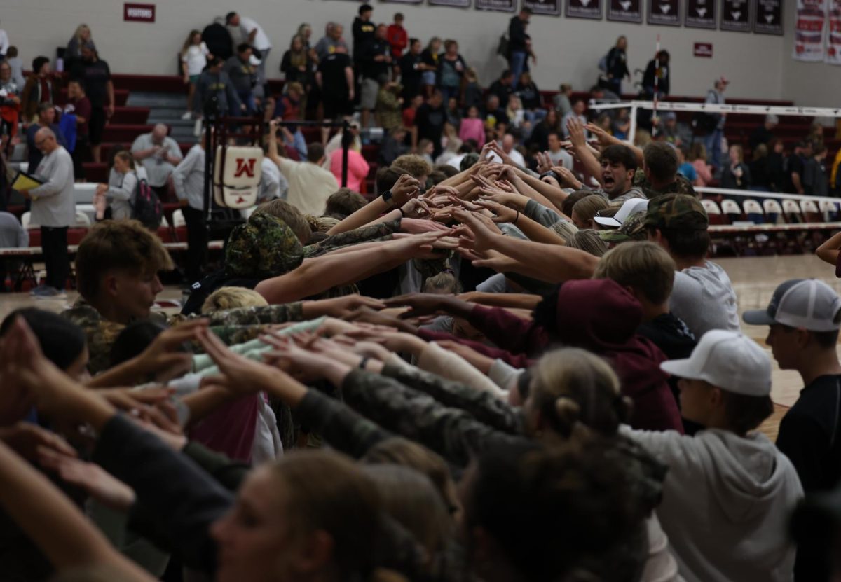 The Mount Vernon student section forms a tunnel after the varsity volleyball game. Mount Vernon ended up winning against Center Point-Urbana 3-0 on Sept. 24. 