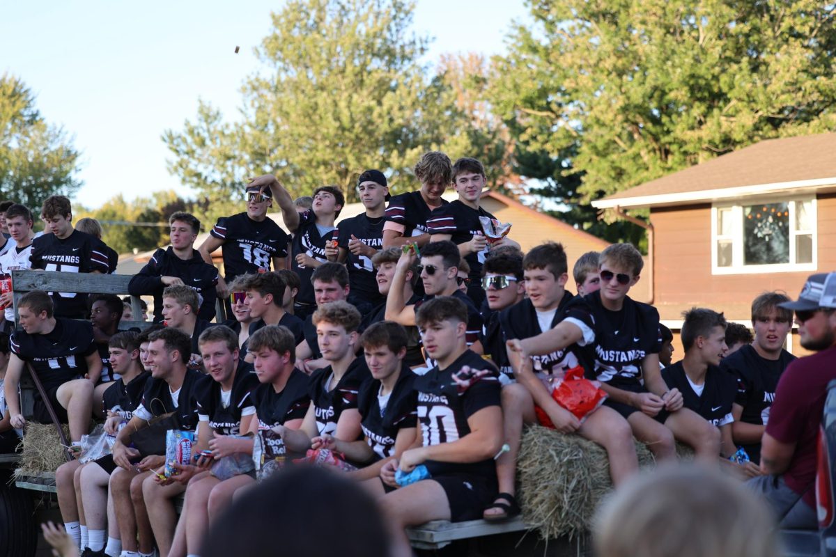 Sophomore Landyn Leyse throws a piece of candy at the crowd of the Hoco parade. 