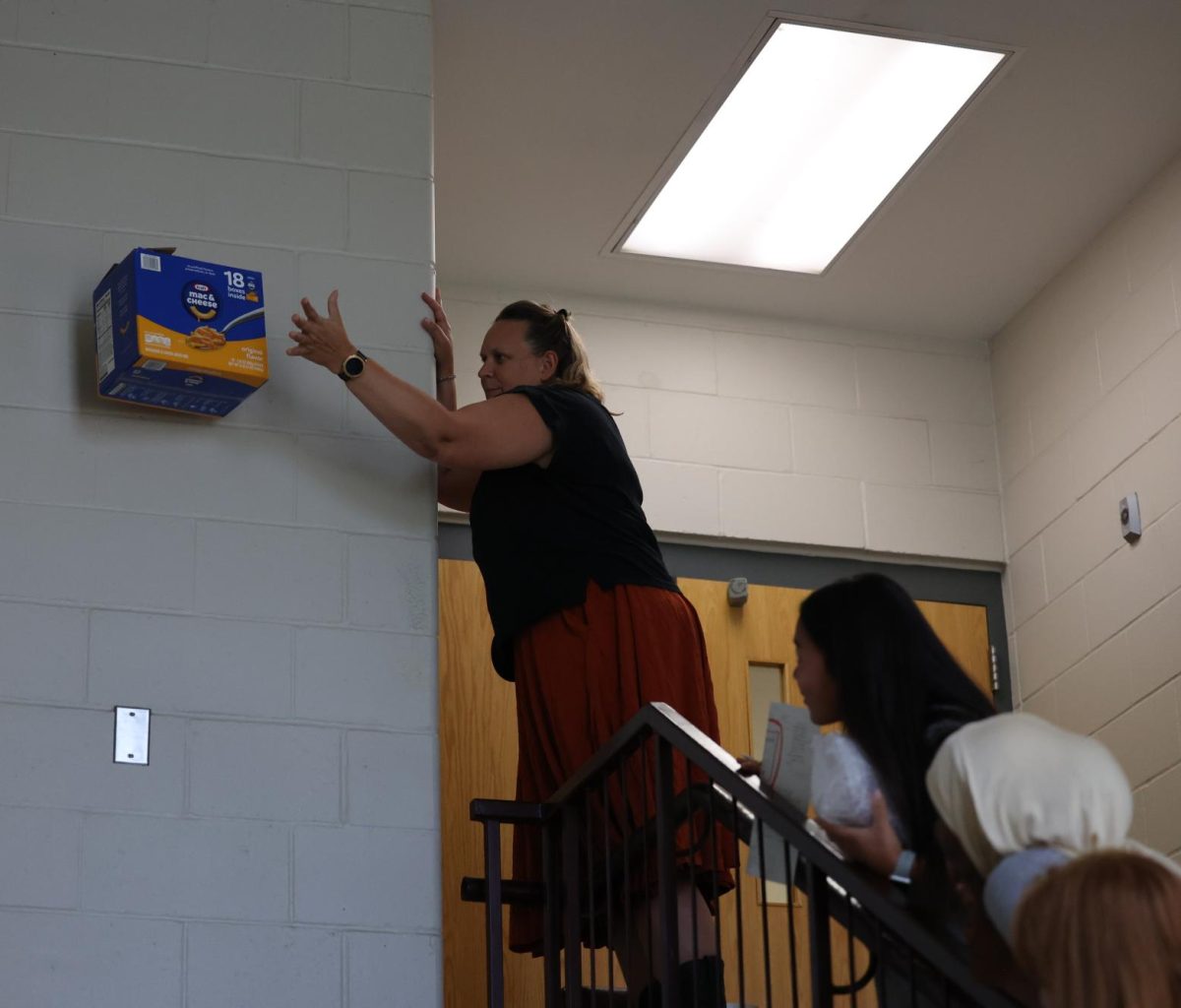 Collage Prep Physics teacher Heather Allen drop a students egg project as the rest of the class watches on Sept. 5. 