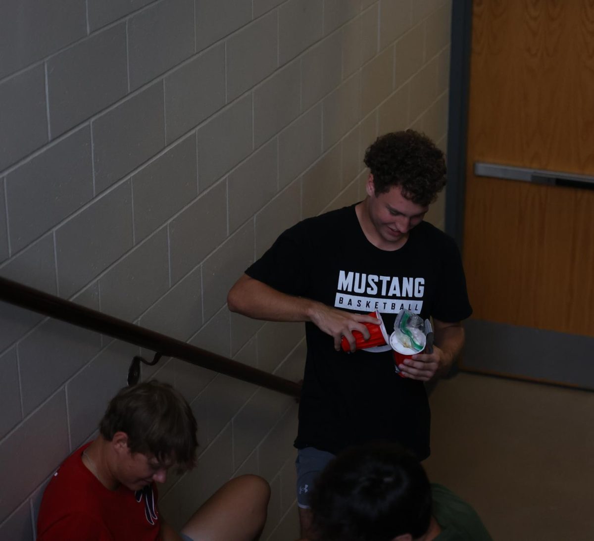 Senior Cole Thurn quickly checks his egg project to see if his egg is uncracked after the fall on Sept. 5. 