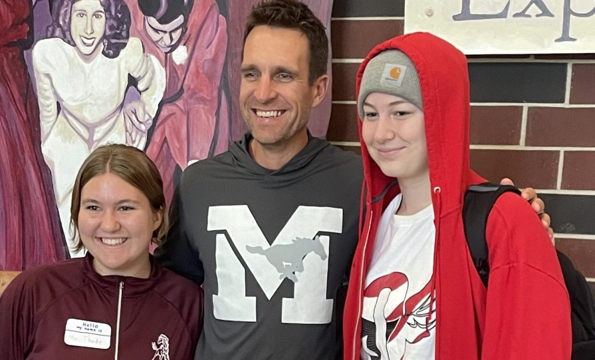 Dressed for Rhyme Without a Reason day are juniors Mae Krapfl and Katie Whitehead posing with their muse athletic director Matt Thede. Krapfl is dressed as Matt Thede while Whitehead is dressed as Slim Shady.