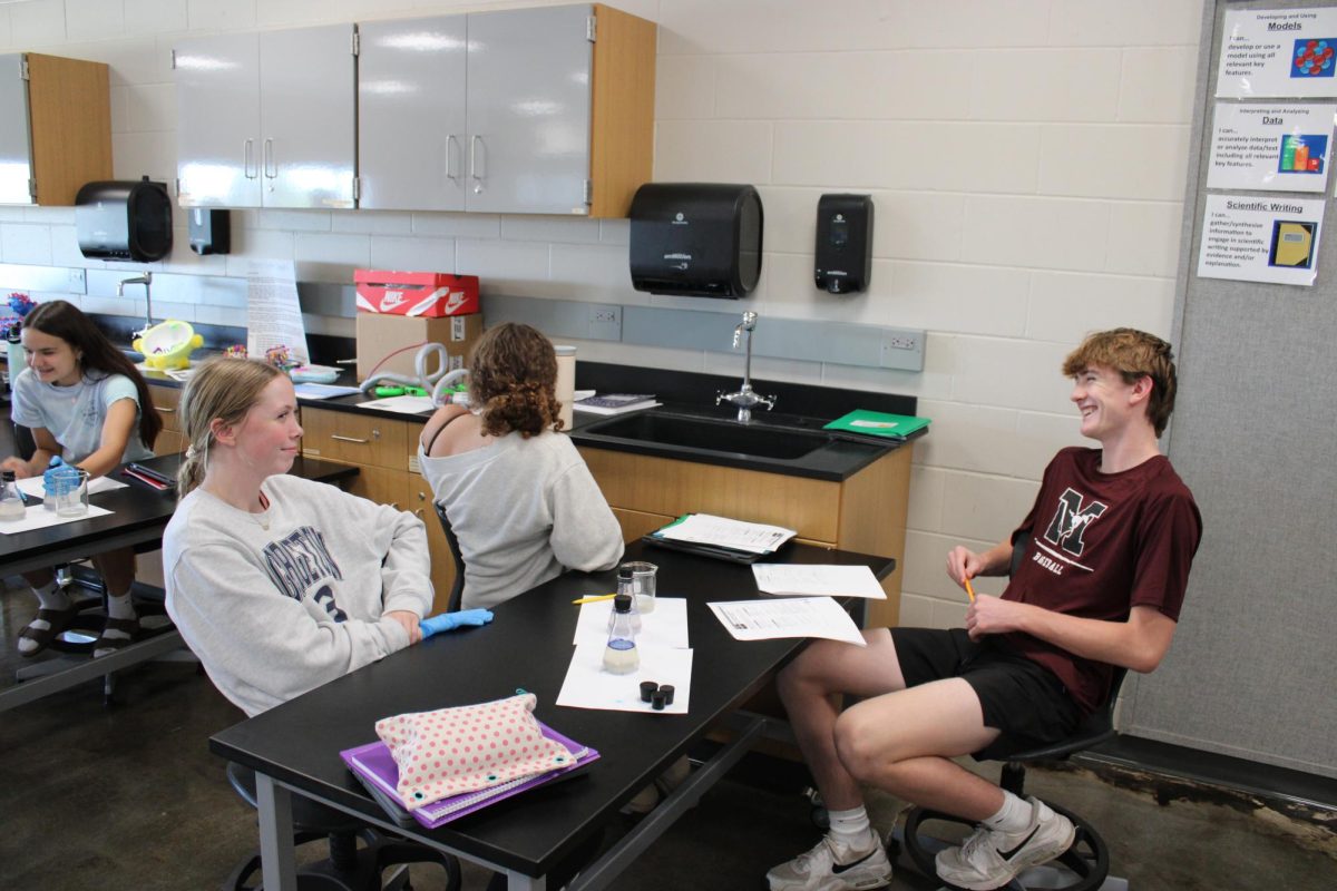 Sophomores Ava Willems, Kendal Hoeppner, and Cole McDermott enjoy their first lab of the year in their Honors Bio class on Sept. 9. 