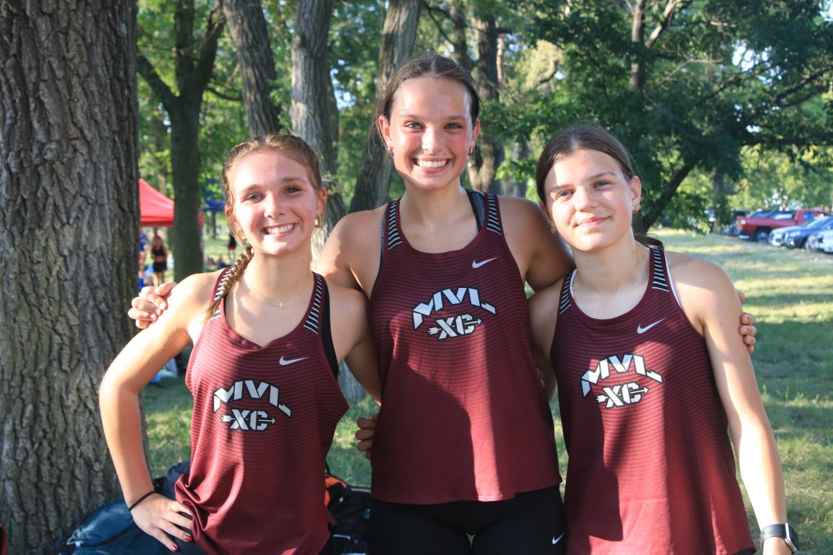 Freshman Elliotte Kinion, Clara Vavricek, and Kate Martin pose for a picture after the JV race at the Ames meet Sept 5. 