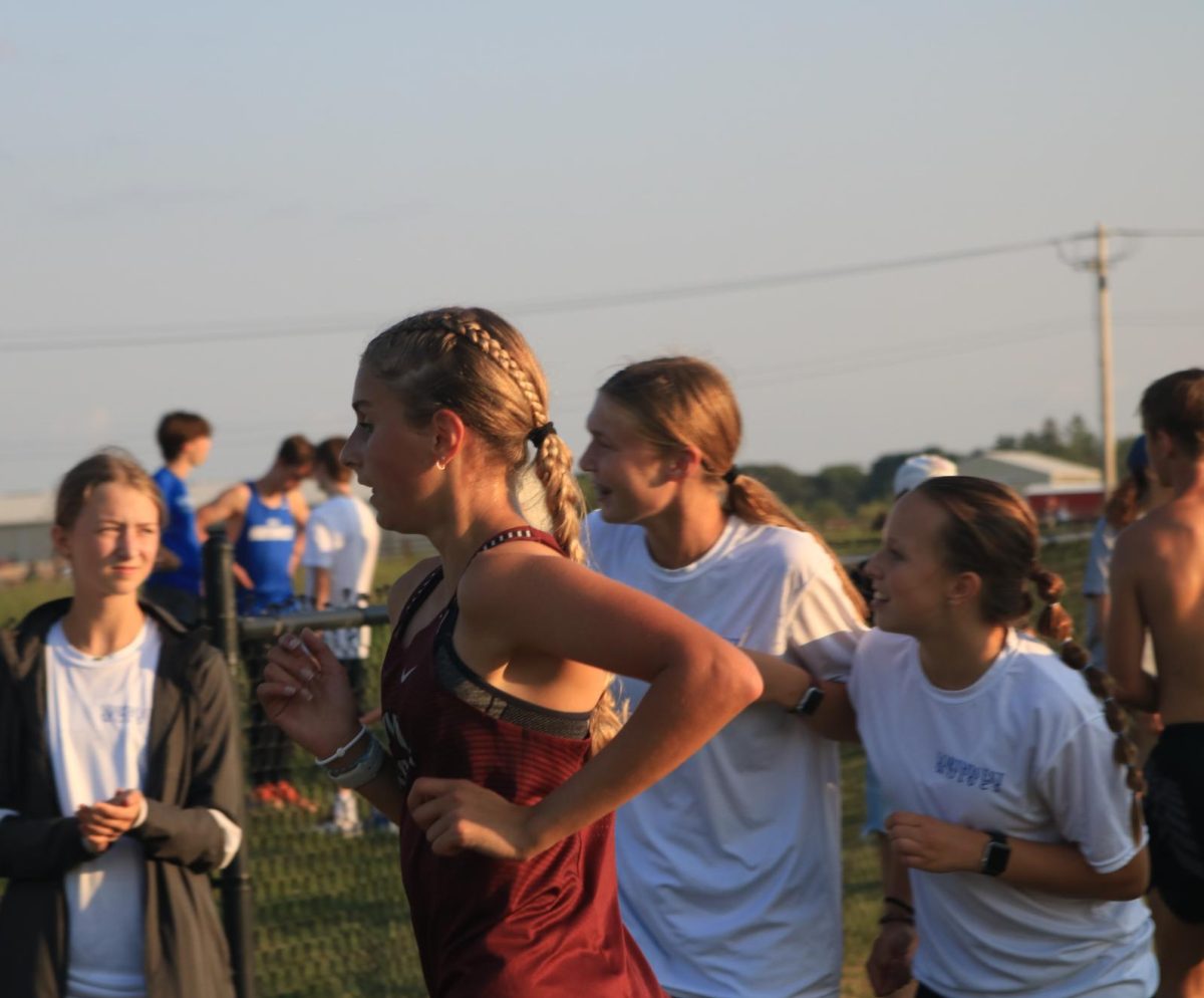 Sophomore Evelyn Moeller runs down the shoot in the  varsity girls race at the Ames meet Sept 5.