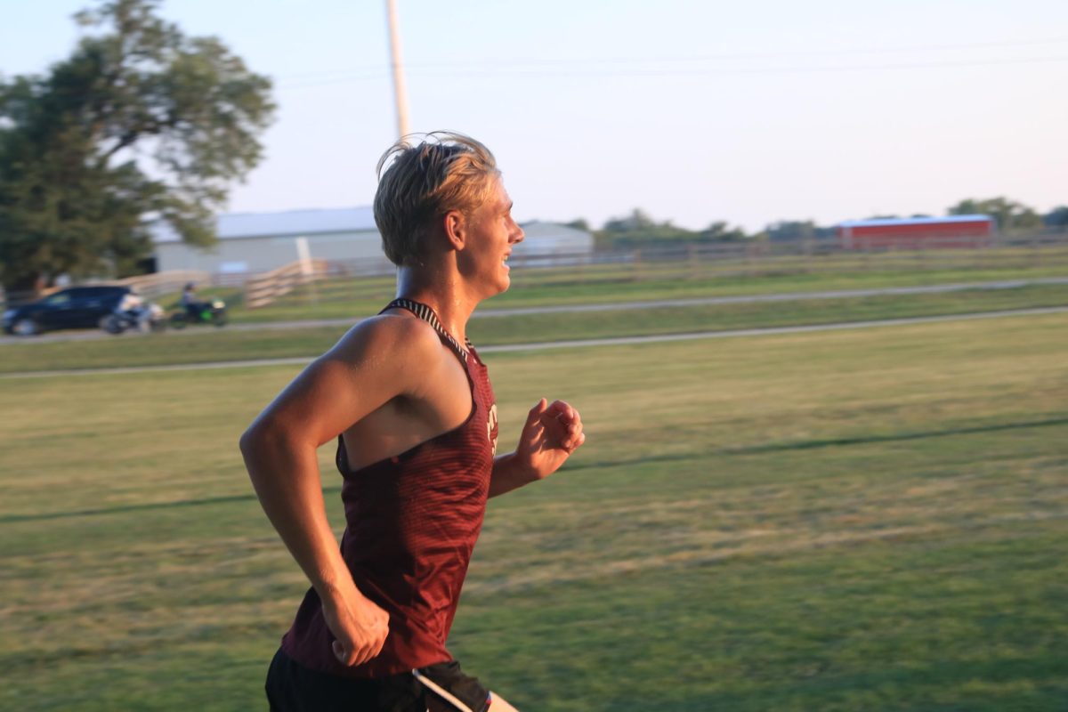 Sophomore Chasen Caskey runs with a half mile left in the varsity boys race at the Ames meet Sept. 5.  