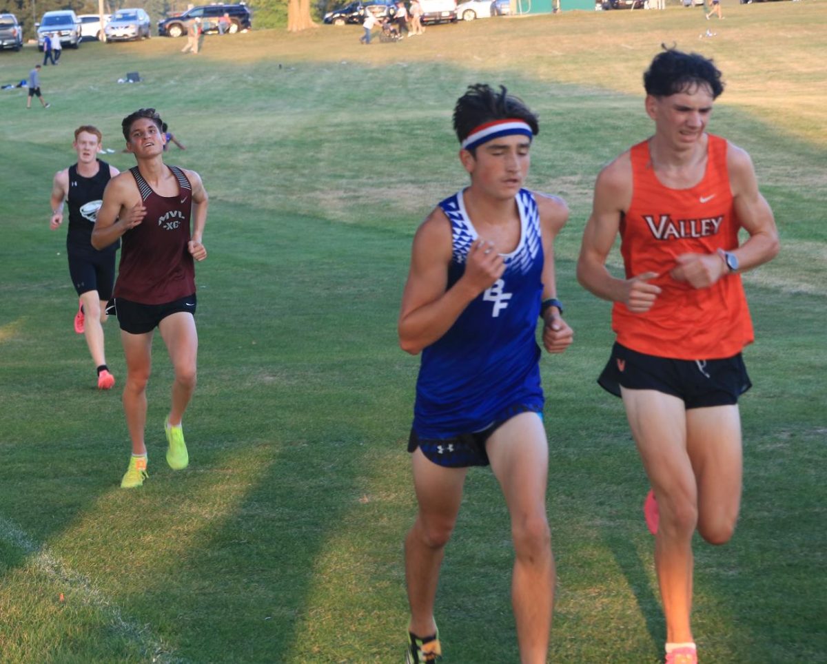 Senior Cayden Scheil starts his kick with a half mile left in the varsity race at the Ames meet Sept 5.   