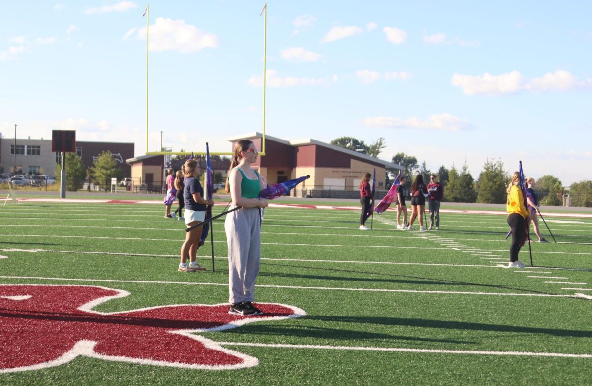 Junior Malena Kohen stands at attention with the rest of the color guard Sept. 6.