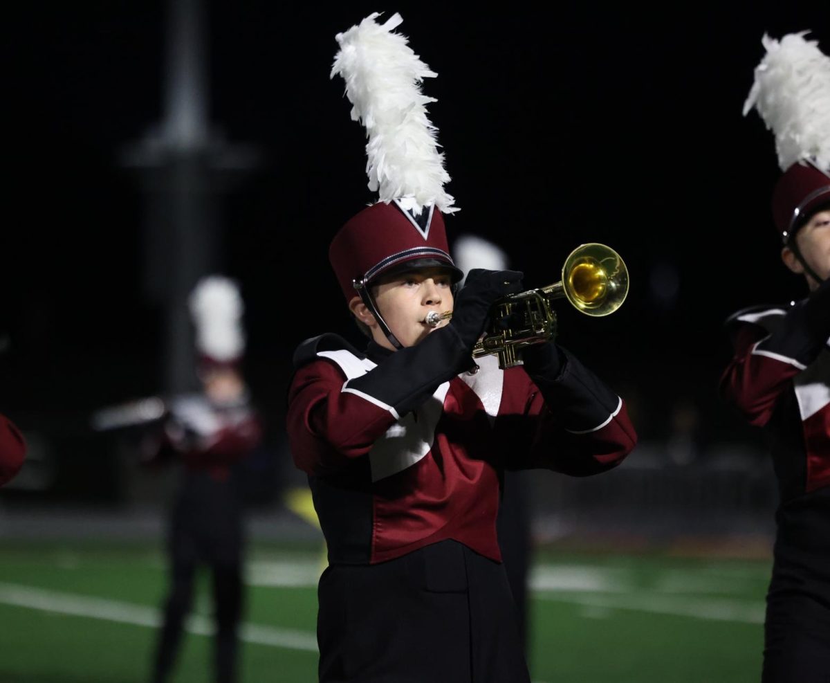 Junior Zachariah Koster attentively marches along with the rest of the band during their halftime performance on Sept. 6.