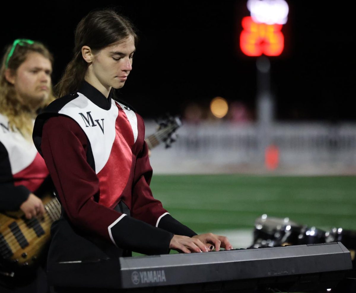 Senior Aisling Smith performs on the keyboard along with the rest of the Marching Mustang. 