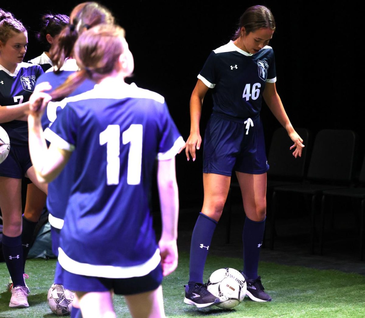 Senior Betsy Louwagie (46) juggles the ball while her teammates look on in confusion. 