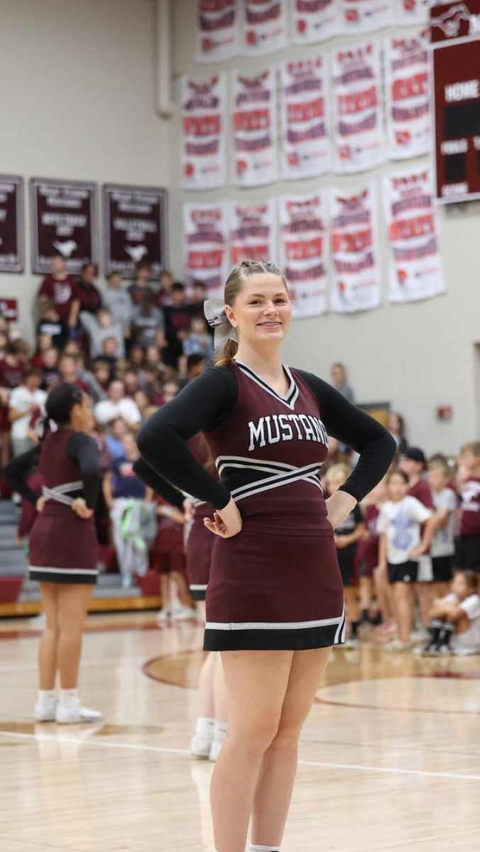 Senior Emma Houghtaling celebrates spirit day in her Mount Vernon Cheer uniform Sept. 27.