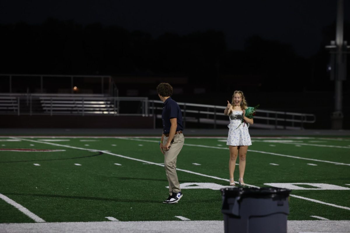 Seamus O'Connor looks back at Natalie Thuerauf giving him a thumbs up after being elected Homecoming King Sept. 26.