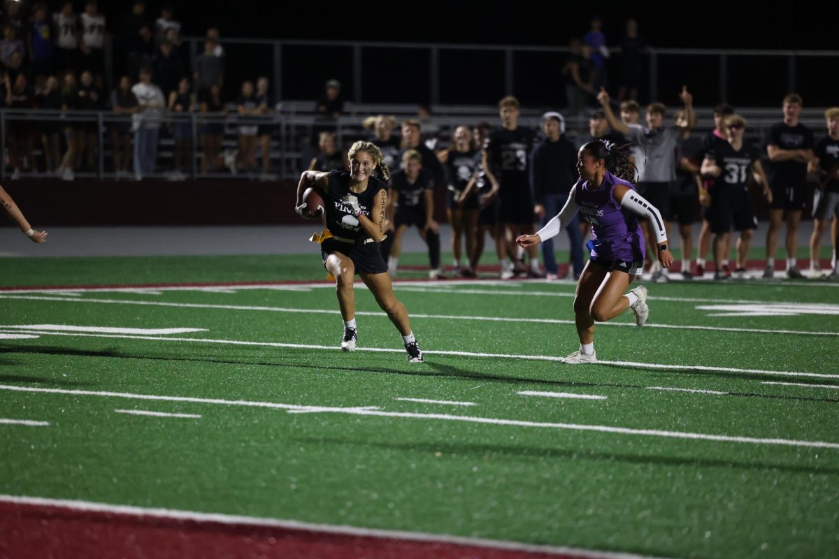 Junior Taylor Frank sprints to the end zone trying to avoid senior Kara Swantz getting her flag Sept. 26.