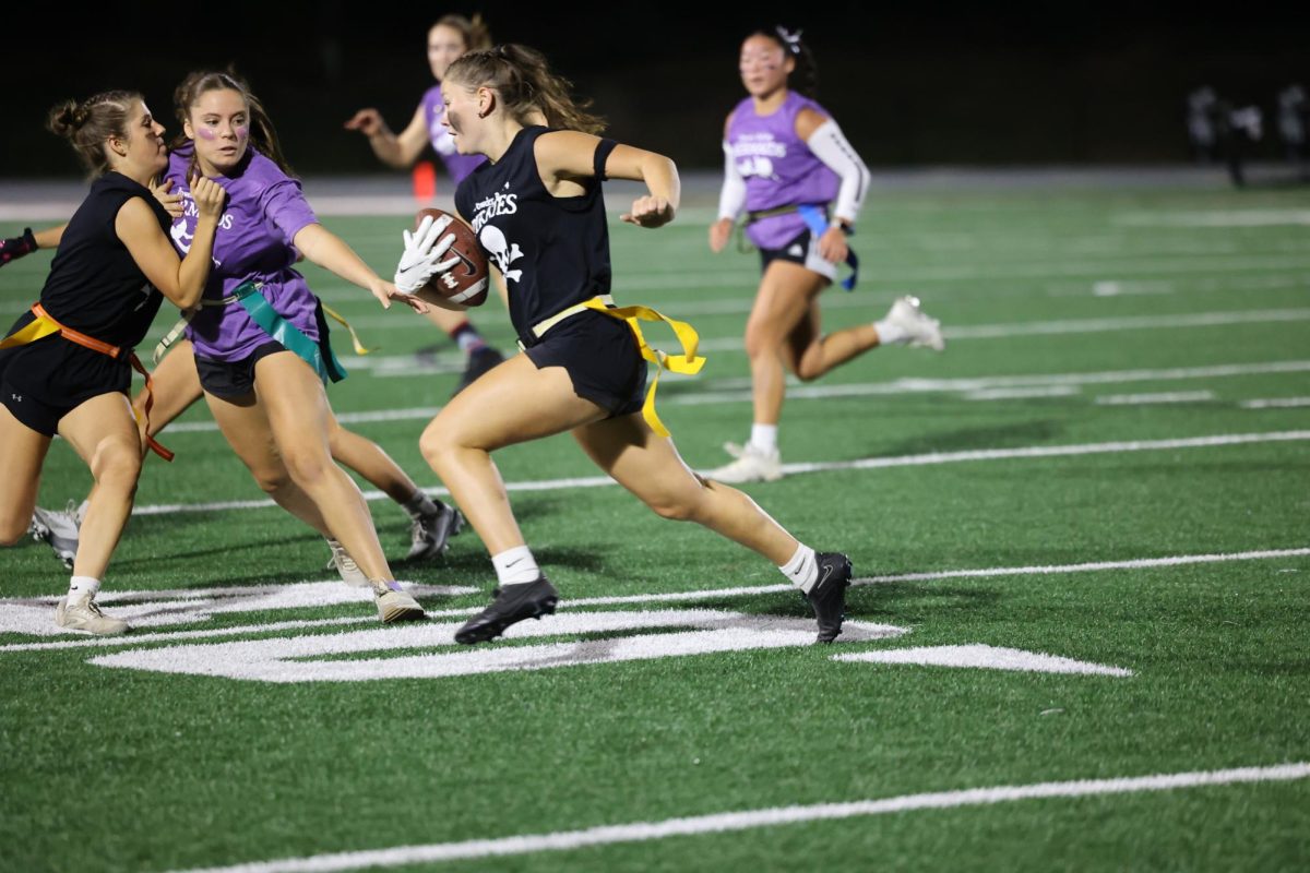 Junior Kiersten Swart blocks senior Renee Vig from grabbing teammate Kaia Swaim's flag Sept. 26. 