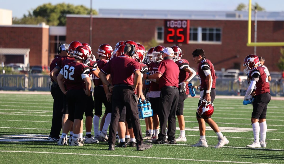 The team huddles around a coach during a timeout on Sept. 6.