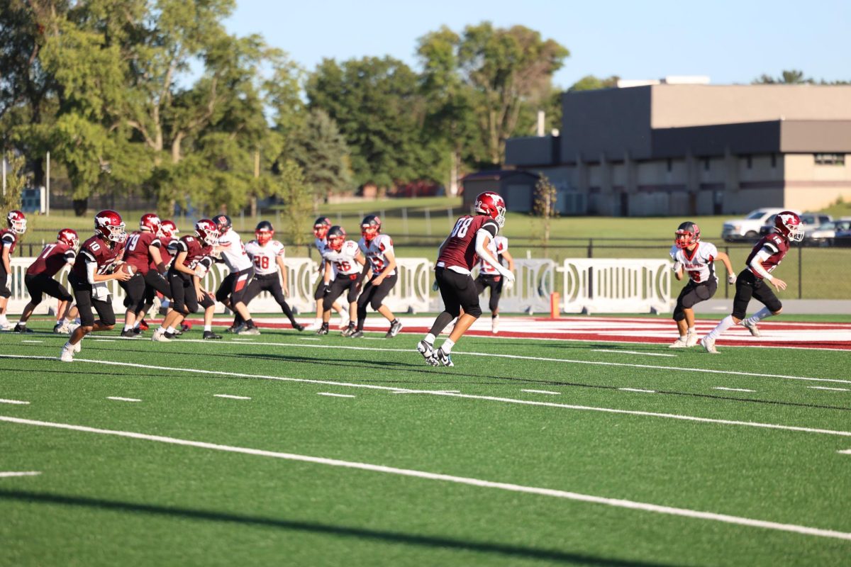 Freshman Quarterback Easton Reasland (10) looks down the field for a target to throw a pass to.