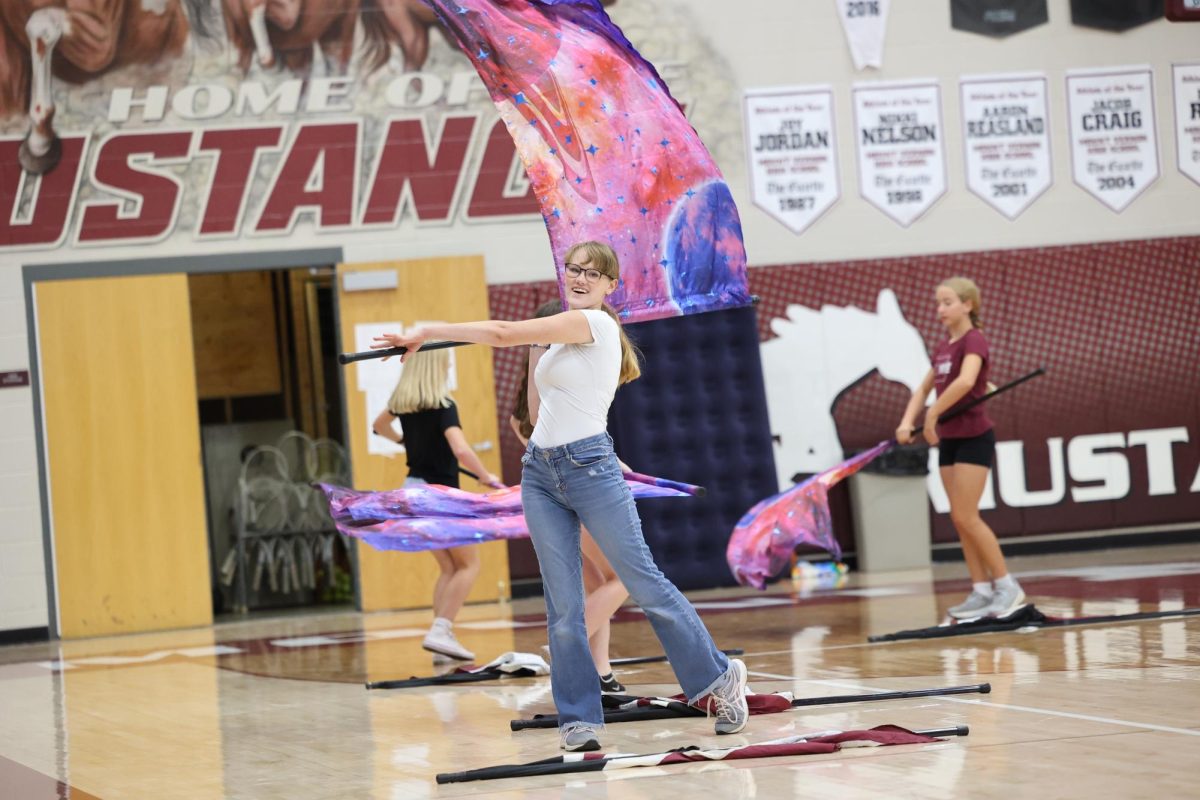 Senior Meg Dye performs in the opening color guard ceremony kicking off the MV Hoco Pep Rally on Sept. 27. 