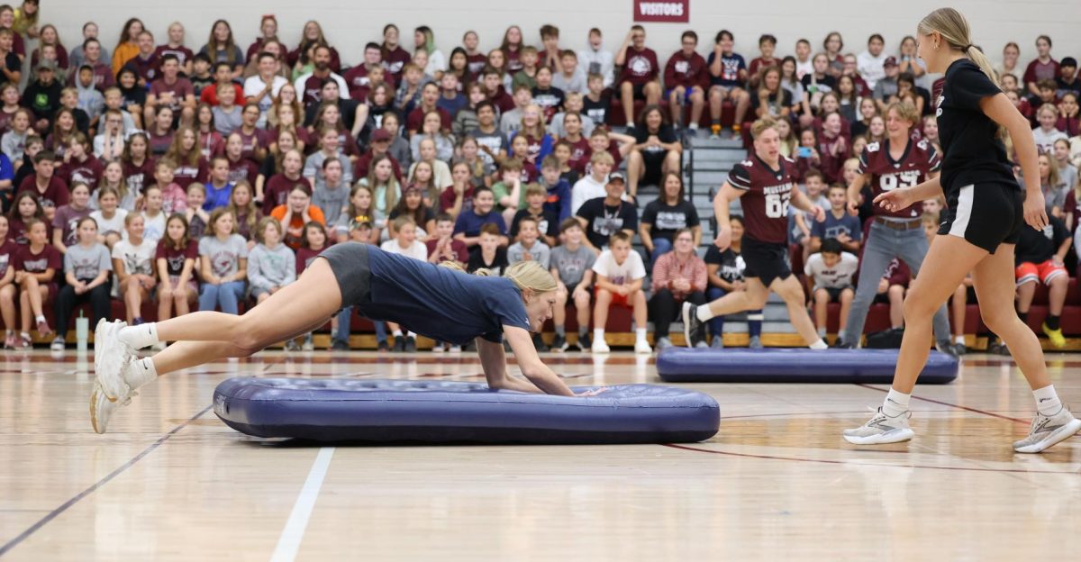 Senior Chloe Meester dives for the inflatable mattress, trying to push it over the finish line during the MV Pep Rally.
 relay race on Sept. 27. 