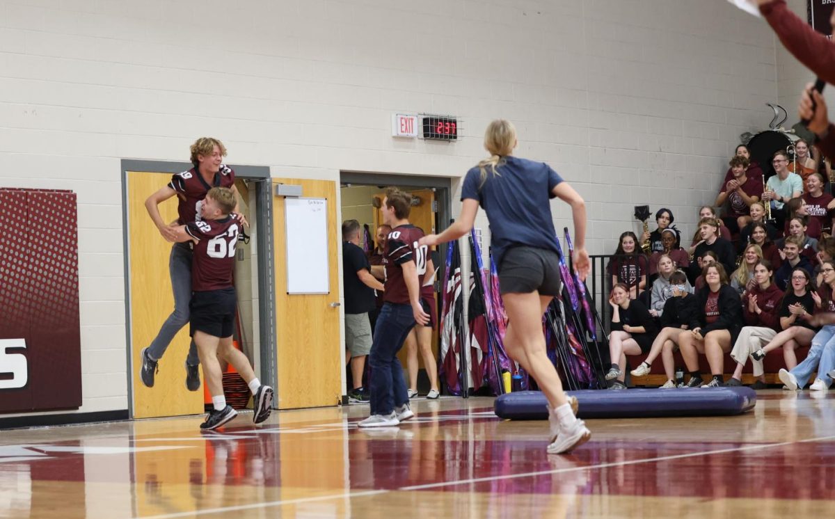 Seniors Kael Riniker and Luke Paulus celebrate their outstanding victory in a relay race involving sliding a mattress on the ground using your body as momentum on Sept. 27. 