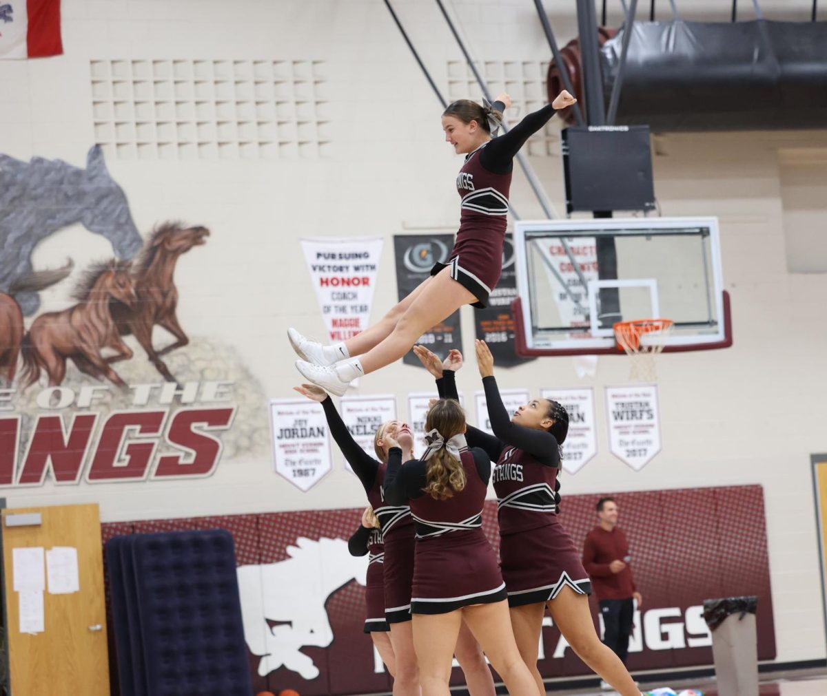 Sophomore Lyn Bauer performs with her fellow cheer leaders in electrifying the crowd the MV Hoco Pep Rally. 