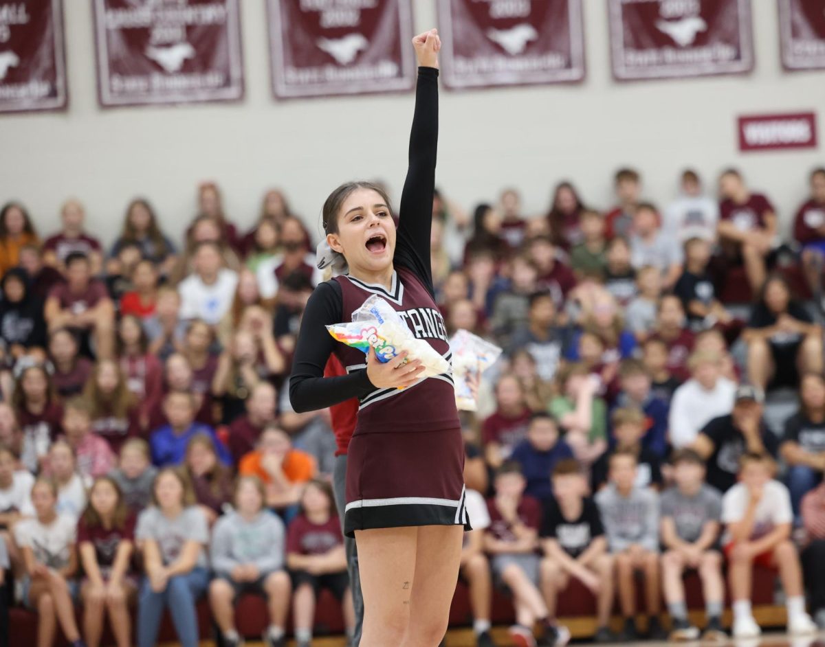 Senior Calista Urmie charges up the crowd before the marshmallow throwing contest at the MV Hoco Pep Rally. 