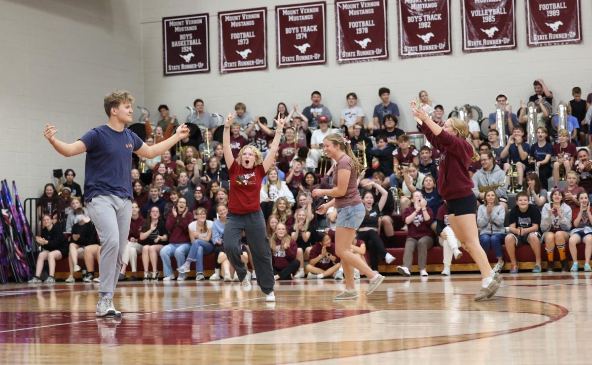 Seniors Cyrus Johnson, Penelope Vig, Natalie Thuerauf, and Selah Loyd celebrate their victory in the marshmallow throwing contest against the cheerleaders on Sept. 27.  