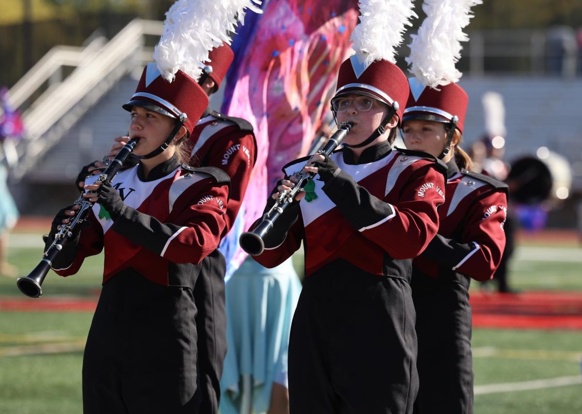 Sophomore Lyn Bauer, freshman Luiza Blacharski, and juniors Willa Turner and Nathan Conrad play together at the marching band competition at Linn Mar.