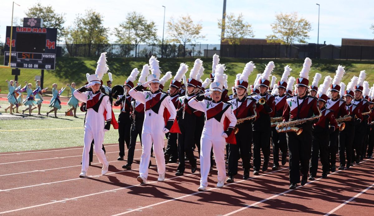 The Marching Mustangs exit the Field after a stunning performance at the Linn Mar competition on Sept. 28. The band won second place, along with Best Drumline and Best Color Guard. 