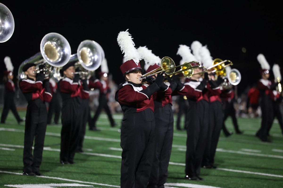 Senior Megan Teague plays her trombone with the band during their football halftime show. 