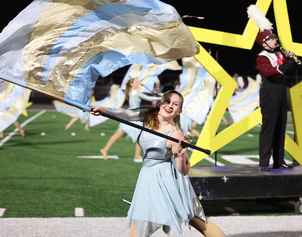 Senior Violet Olinger flies her colors during her solo on Oct. 11. 