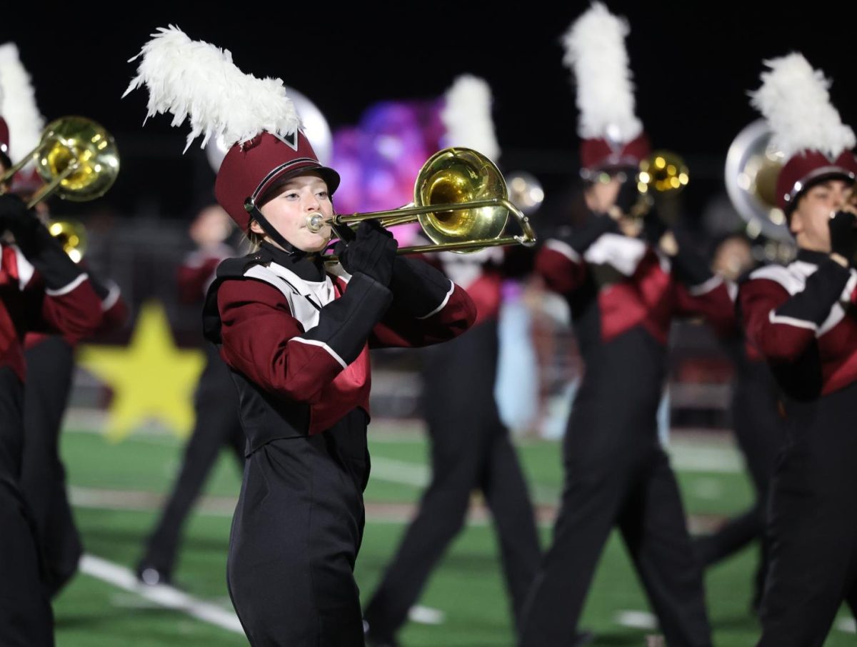 Junior Claire Thuerauf marches with the band duirng their performance on Oct. 11.