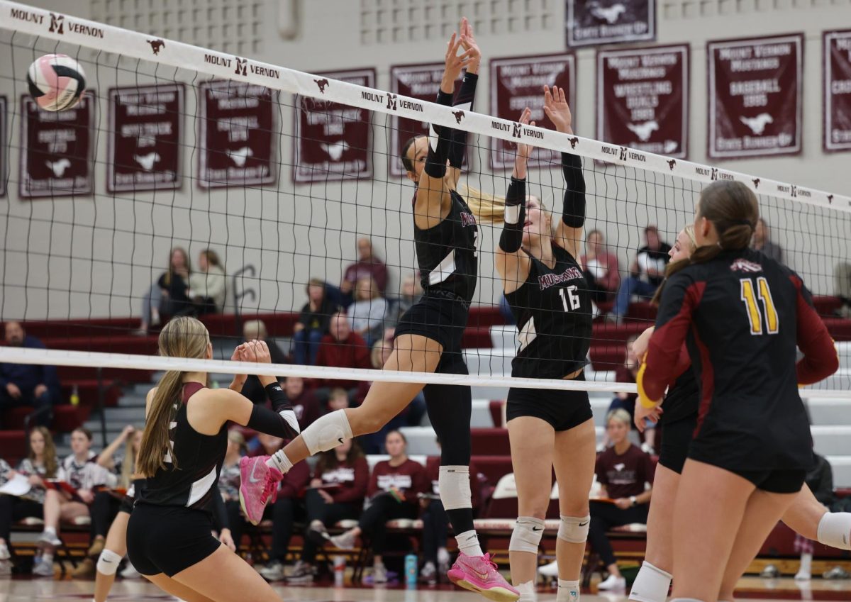 Senior Chloe Meester (16) and sophomore CaliAna Whitaker (3) watch as the volleyball passes through their block Oct. 24. 