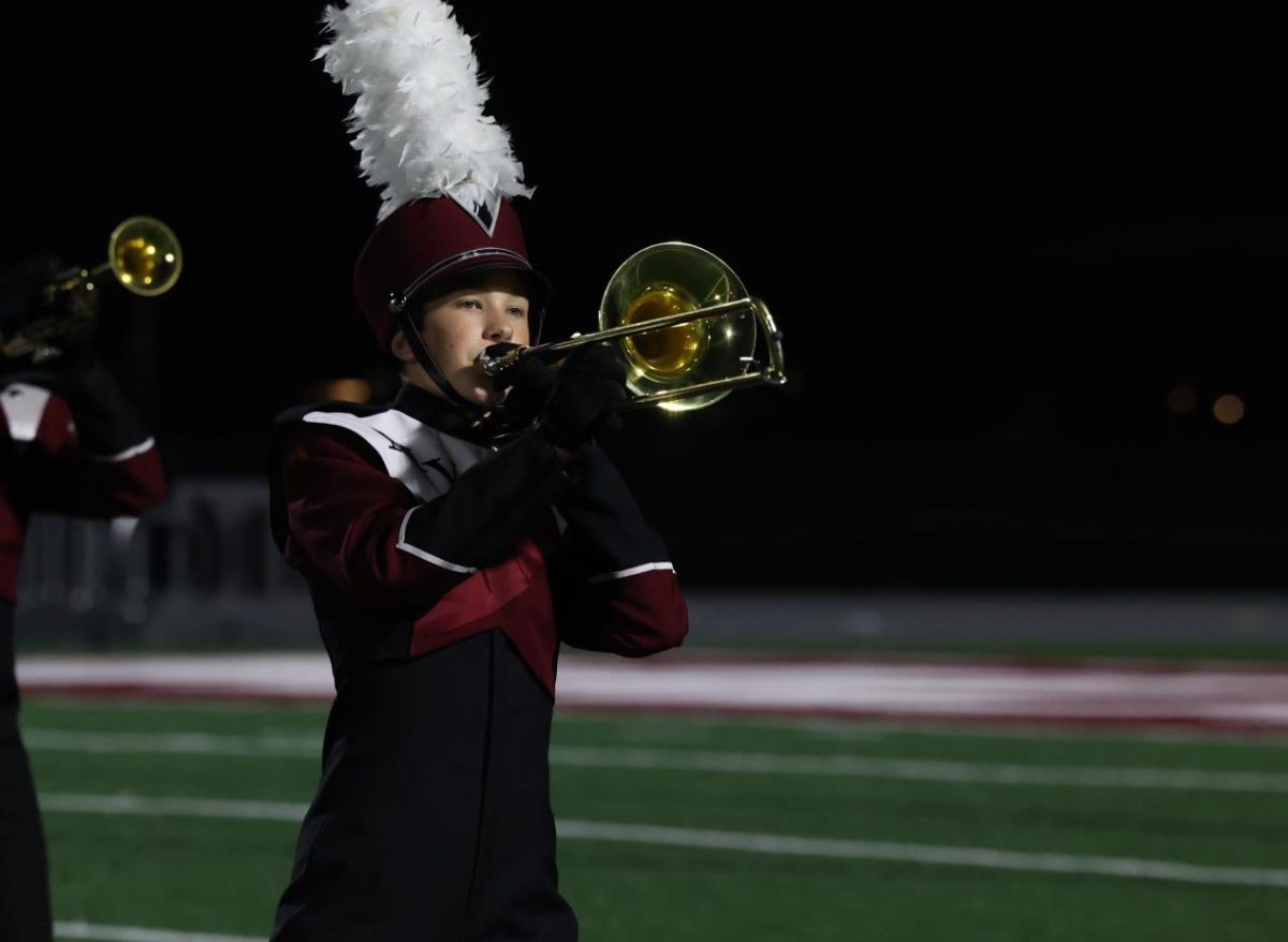 Freshman John Puetz plays with the Marching Mustangs during their final performance.