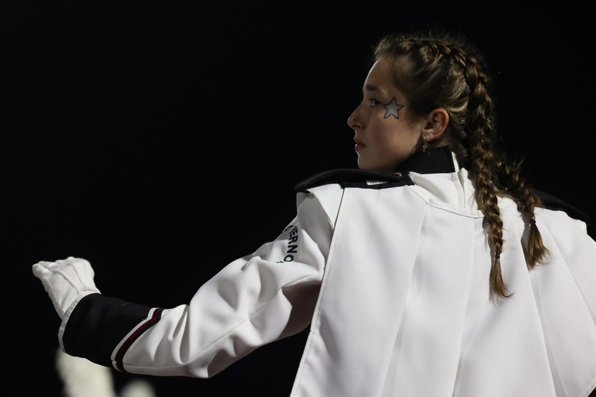 Senior Drum Major Clare Nydegger conducts the Marching Mustangs for a final time during their performance on Oct. 28. 