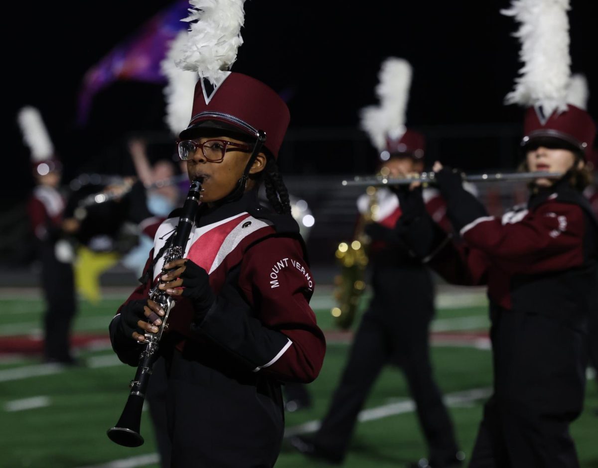 Junior Elena Gehrke marches along with the band during their last show of the year.