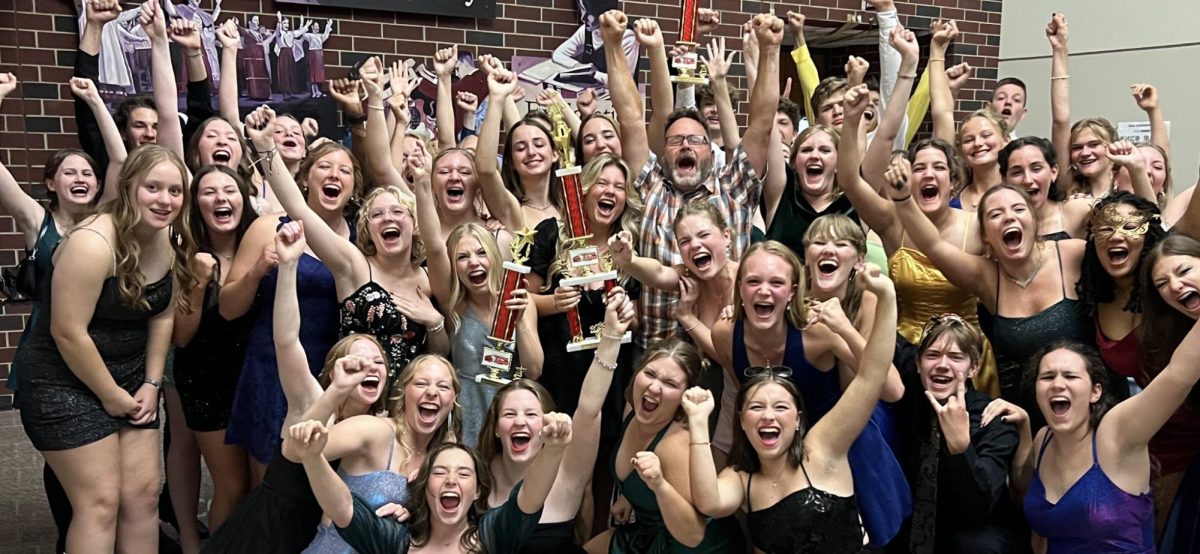 Band students celebrate at the Homecoming Dance when Band Instructor Scott Weber delivered their trophies from the competition earlier in the day. The Marching Mustangs won Best Drumline and Best Color Guard and placed second overall in Marion Sept. 28.