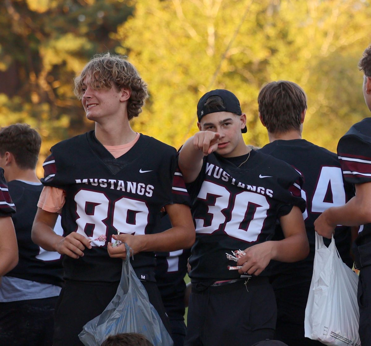 Junior Celeb Keegan points at the photographer while senior Luke Paulus grabs candy to throw at the crowd during the MV Hoco parade. 