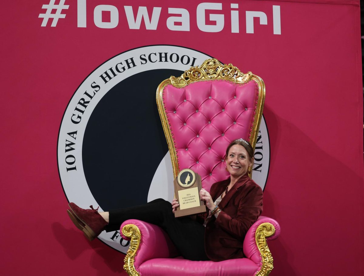 Head coach Maggie Willems poses on a throne after winning the State Championship Volleyball game. The Mustangs ended up winning their game against Western Christian 3-0 on Nov. 7.