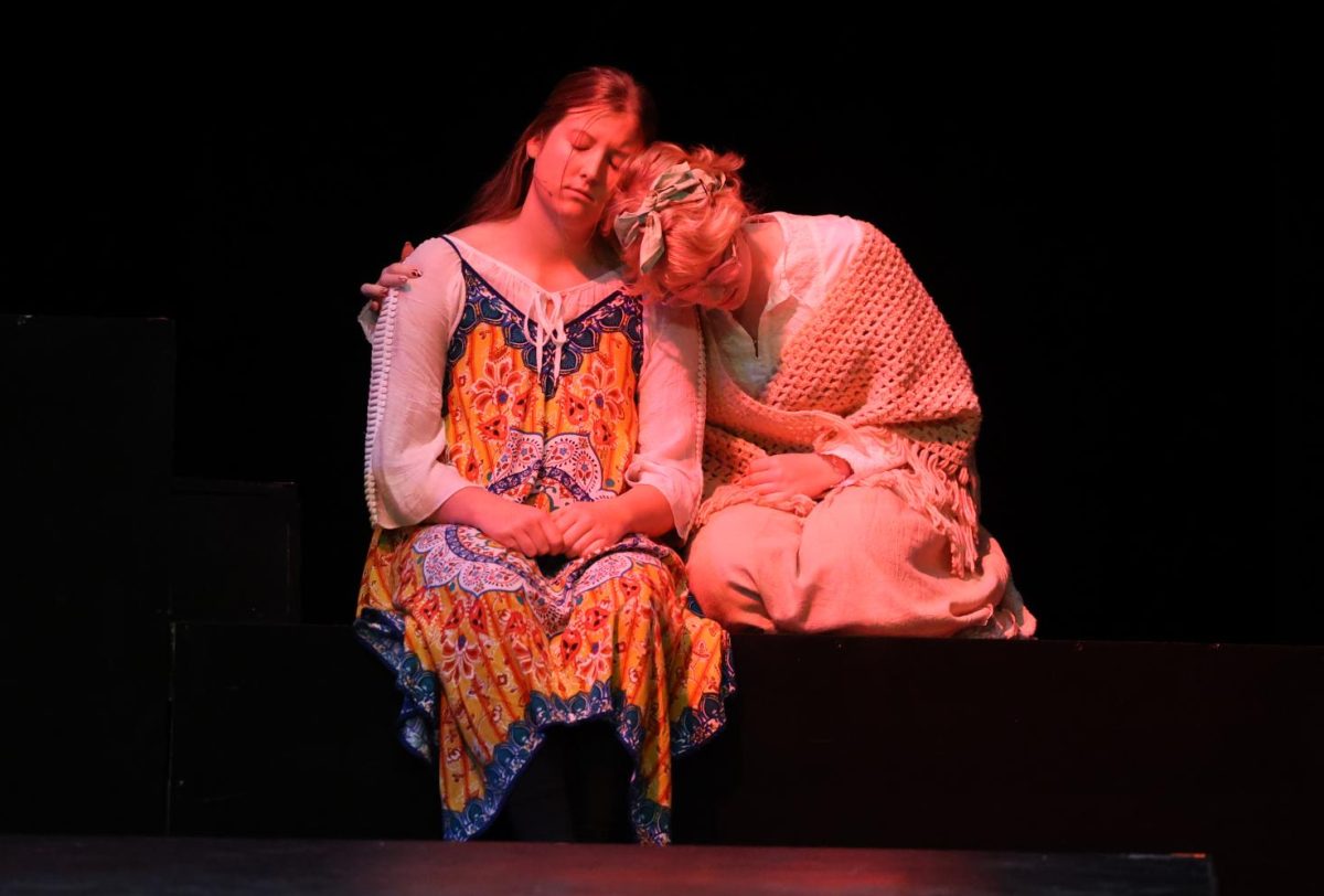 Seniors Selah Loyd (Yolie) and Penelope Vig (Kat) hold each other in despair.