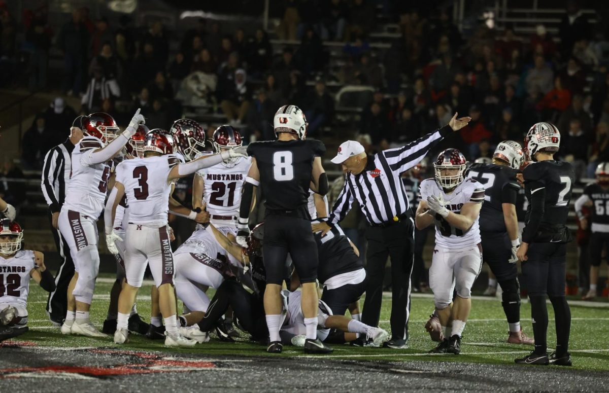 Refs and players argue over possession of the ball.