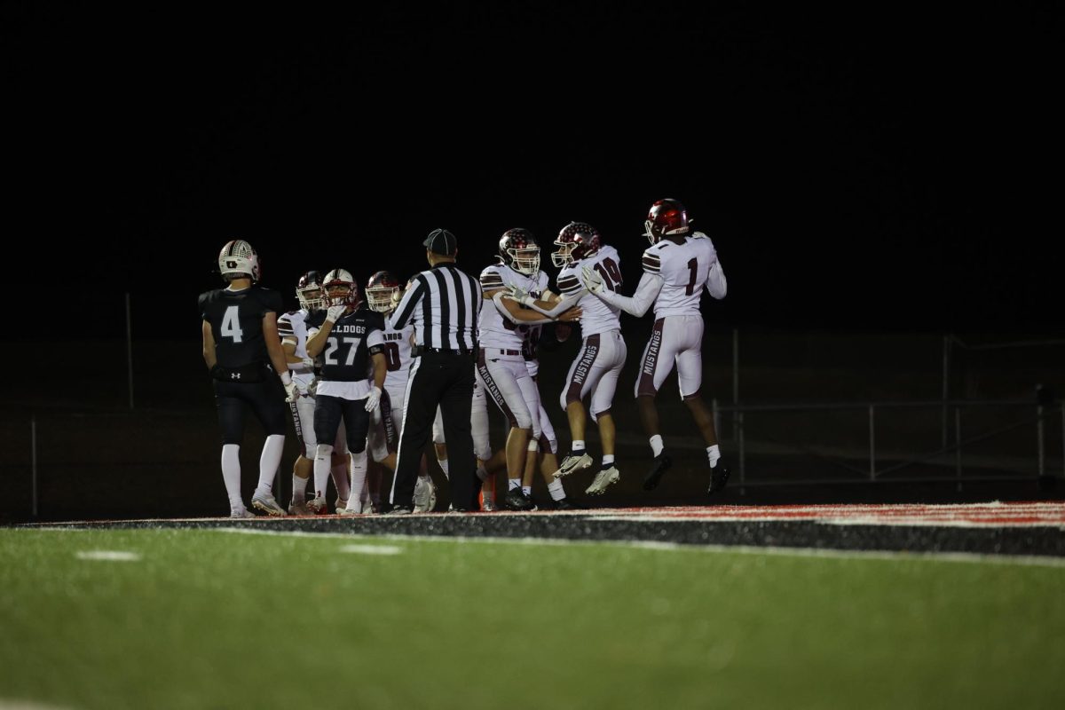 Mustang players celebrate their touchdown during the 31-28 Algona game.