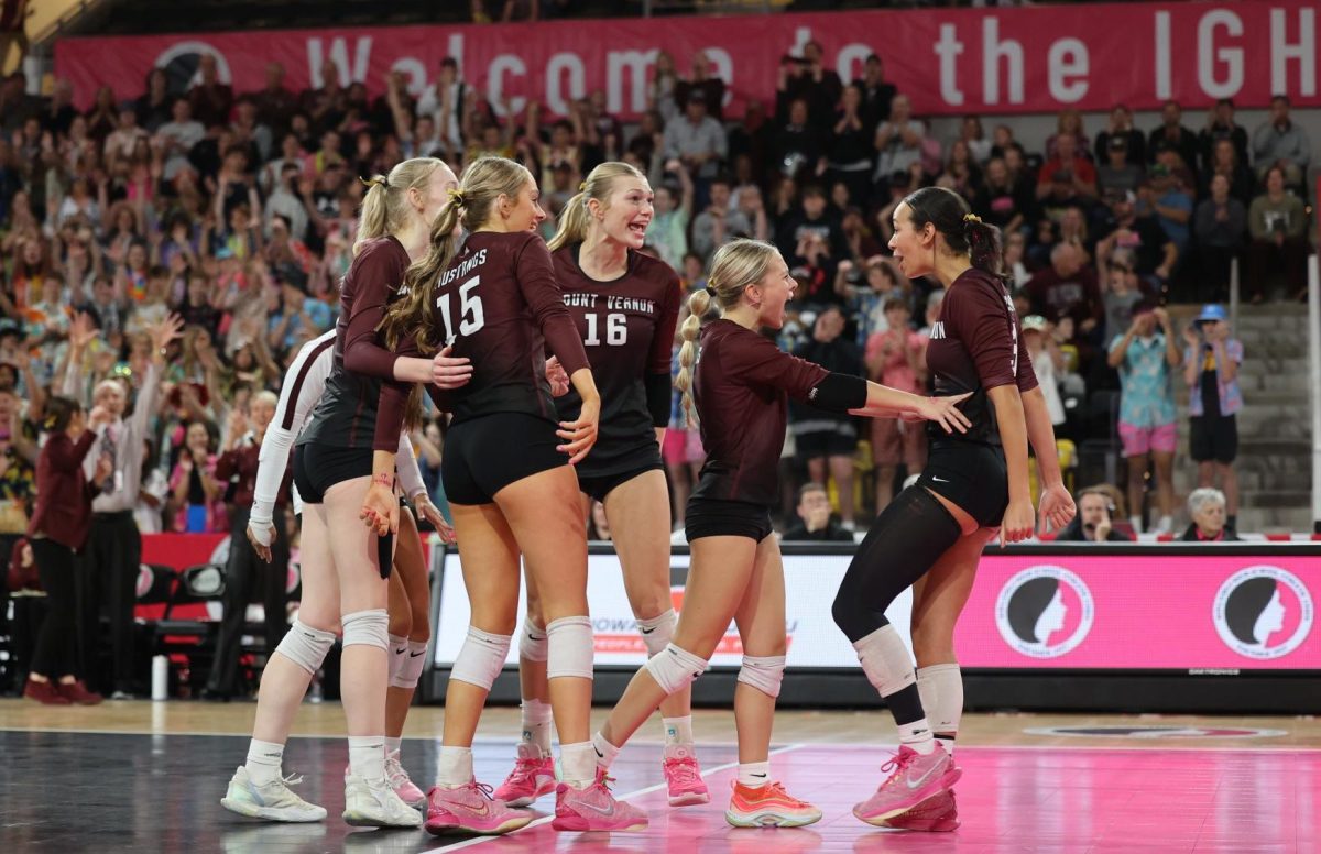 The Mustang volleyball team cheer after a kill is made by Junior CaliAna Whitaker (3) Nov. 7.