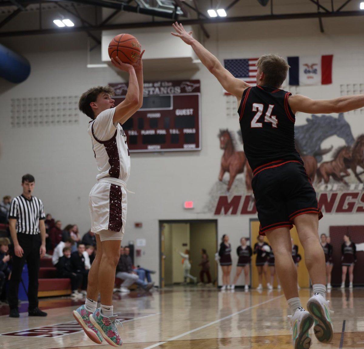 Sophomore Luke Rushford (3) jumps to shoot the ball Dec. 13. 