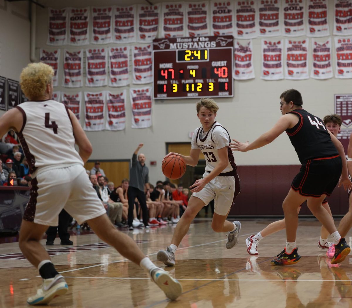 Sophomore Seth Rushford (33) weaves around his Williamsburg opponent Dec. 13.