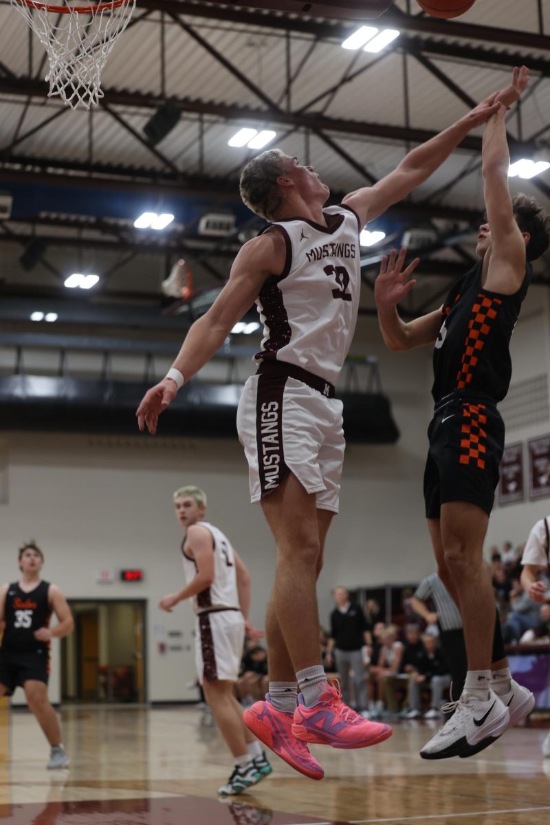 Senior Josef Briesemeister (32) jumps to block his Solon opponents shot. The Mustangs ended up winning against Solon 54-40 on Dec. 17. 